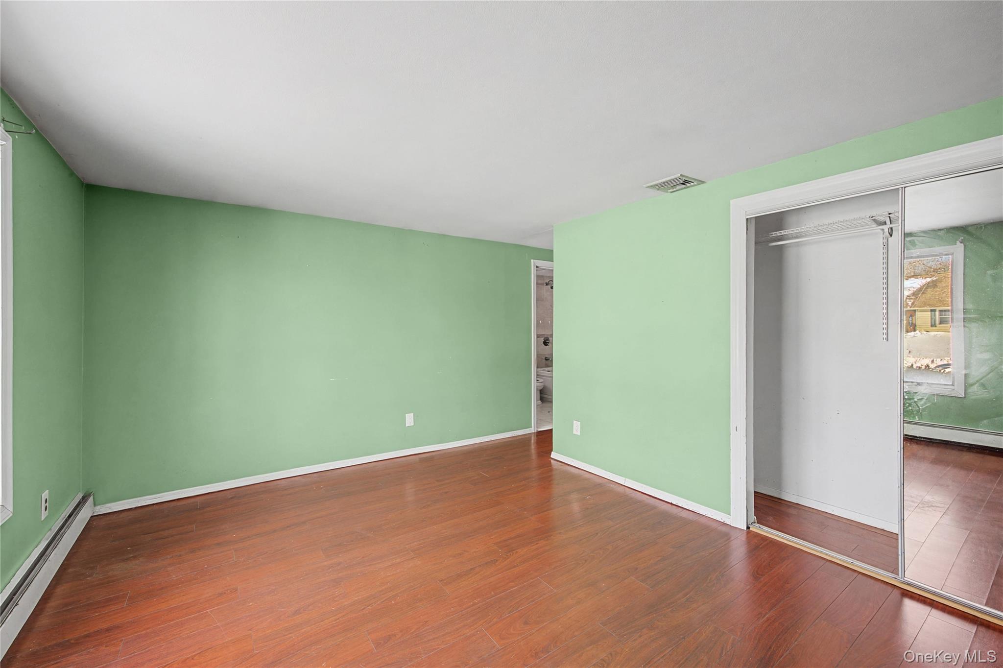 18 Woodbrook Drive Ridge, NY 11961 - Photo 30 of 33 an empty room with wooden floor and windows