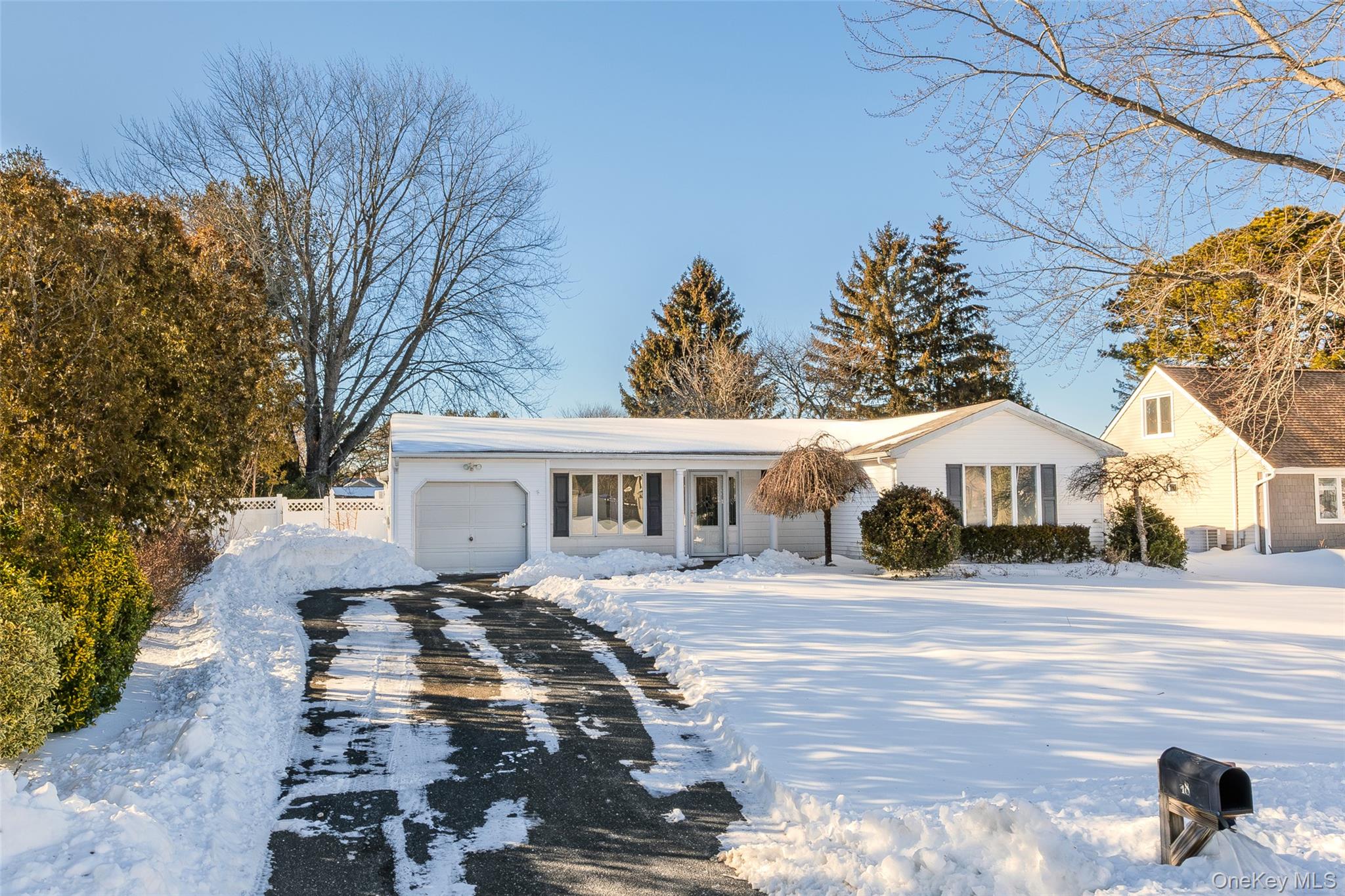 18 Woodbrook Drive Ridge, NY 11961 - Photo 3 of 33 a front view of a house with a yard