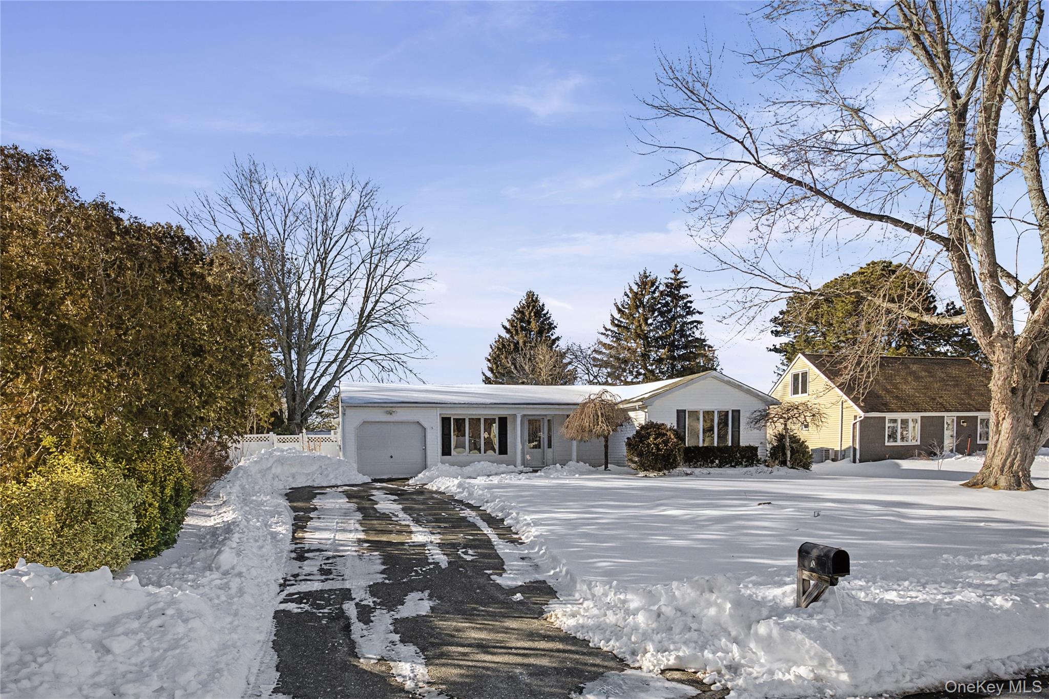 18 Woodbrook Drive Ridge, NY 11961 - Photo 4 of 33 a front view of a house with a yard