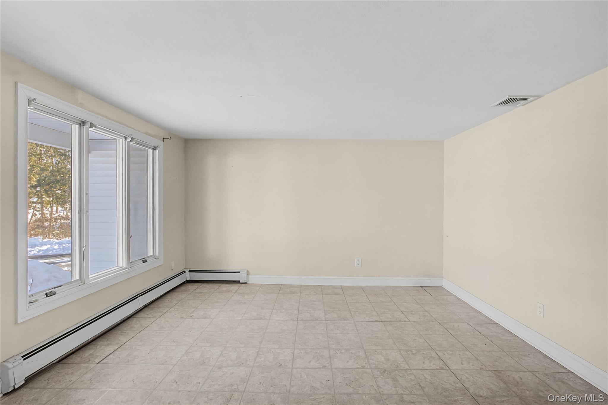 18 Woodbrook Drive Ridge, NY 11961 - Photo 9 of 33 an empty room with windows