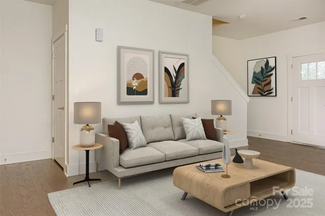 a living room with furniture and a wooden floor