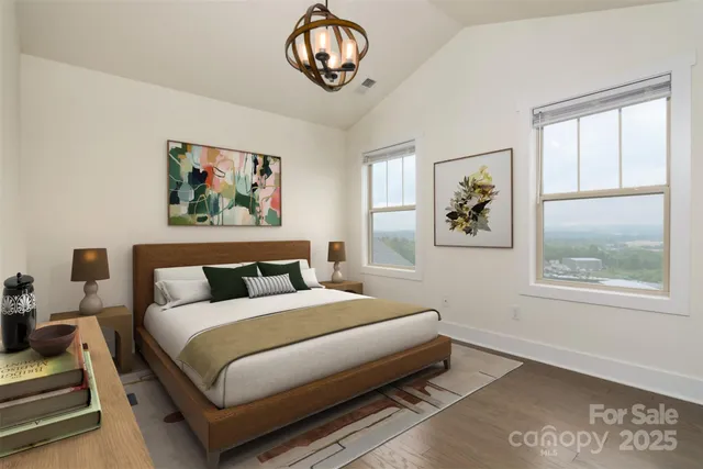 a bedroom with a bed and a painting on the wall