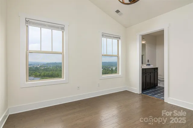 an empty room with windows and closet