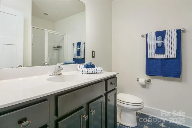 a bathroom with a sink toilet and mirror