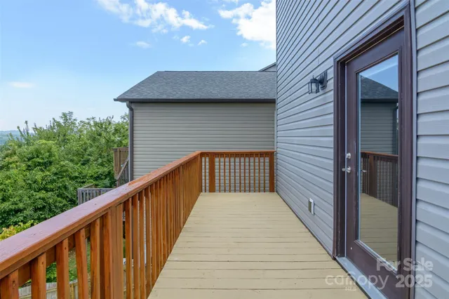 a view of a balcony with wooden floor