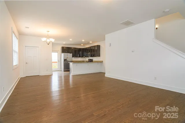 a view of a kitchen with a sink and a refrigerator