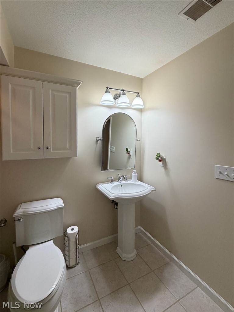 1343 Courtland Road Weirton, WV 26062 - Photo 44 of 50 Half bathroom featuring a textured ceiling and light tile patterned flooring