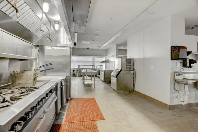 a kitchen with furniture a stove and a refrigerator