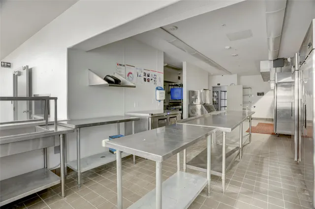 a kitchen with kitchen island a table and chairs in it