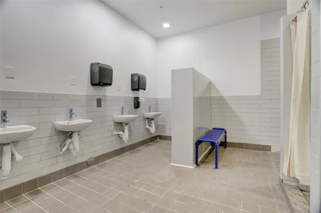 a bathroom with a shower and a glass door