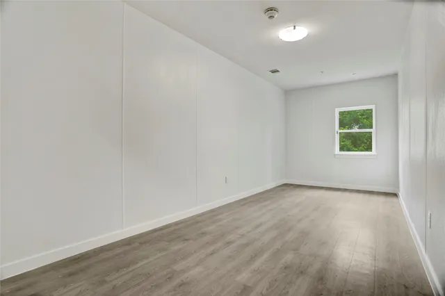 a view of a white house with a yard