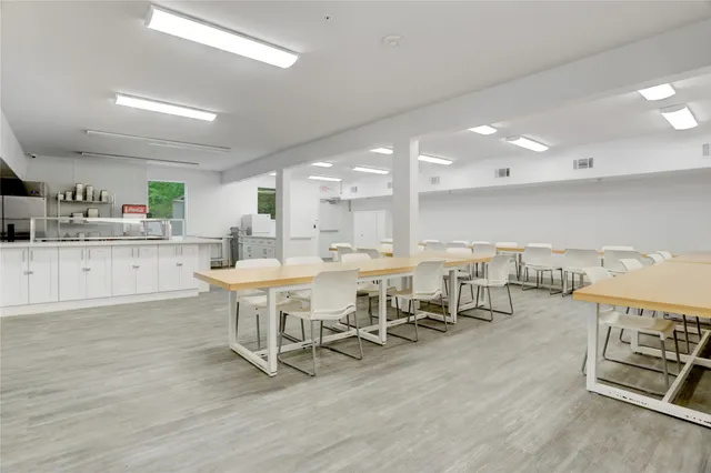 a large kitchen with a table and chairs in it