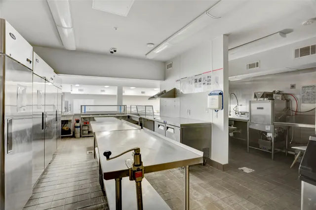 a kitchen with counter top space and stainless steel appliances