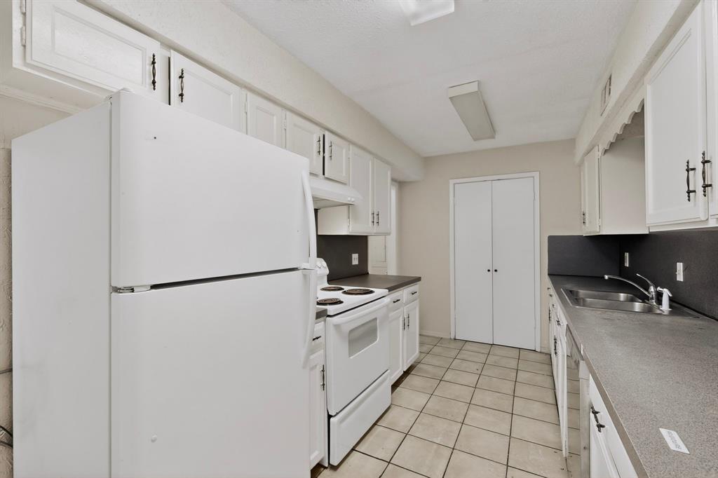 703 East Shady Grove Road Irving, TX 75060 - Photo 12 of 40 a white refrigerator freezer sitting inside of a kitchen