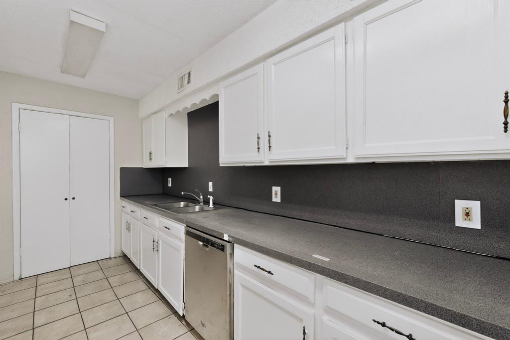 703 East Shady Grove Road Irving, TX 75060 - Photo 13 of 40 a kitchen with stainless steel appliances granite countertop a sink and a stove
