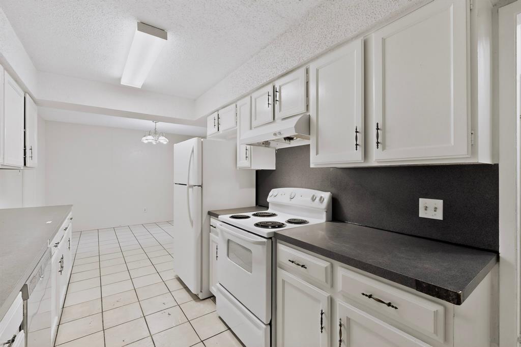 703 East Shady Grove Road Irving, TX 75060 - Photo 14 of 40 a kitchen with stainless steel appliances granite countertop a refrigerator sink and white cabinets