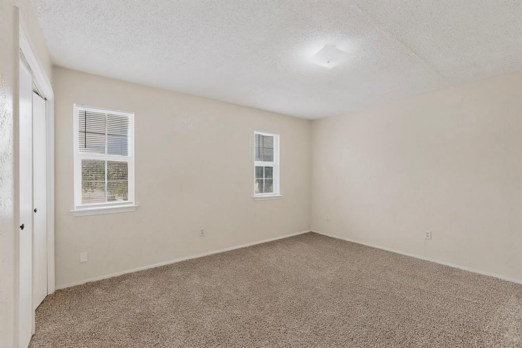 703 East Shady Grove Road Irving, TX 75060 - Photo 27 of 40 an empty room with windows