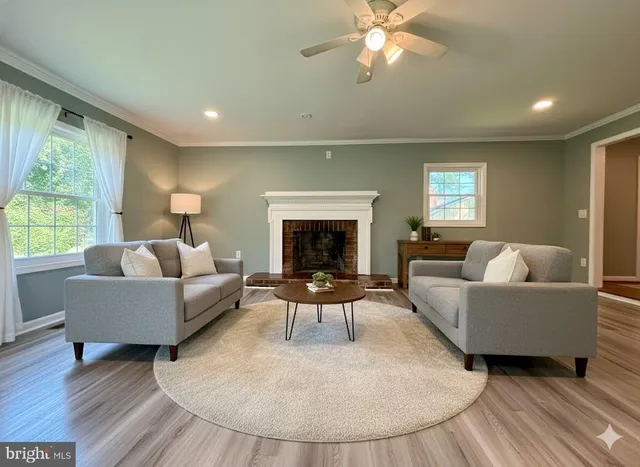 a living room with furniture and a fireplace