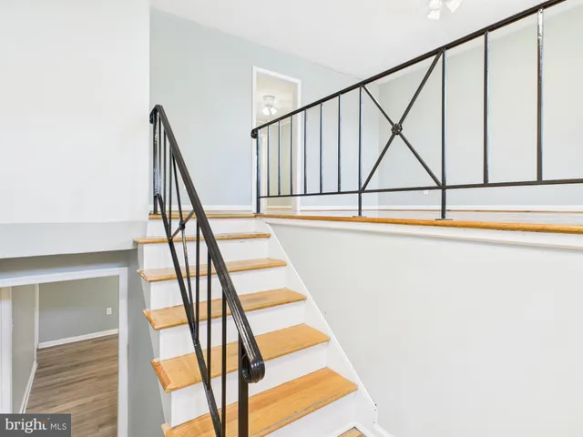 a view of staircase with white walls and a window