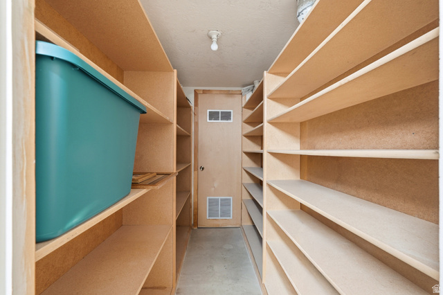 270 East 700 North Logan, UT 84321 - Photo 29 of 42 Dedicated storage room featuring extensive built-in shelving, concrete flooring