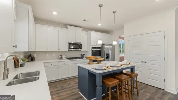 a view of kitchen with cabinets and wooden floor