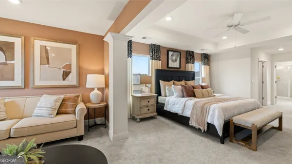 a bedroom with a bed and a painting on the wall