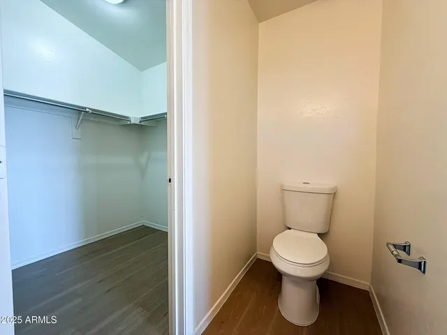 a white toilet sitting next to a white sink