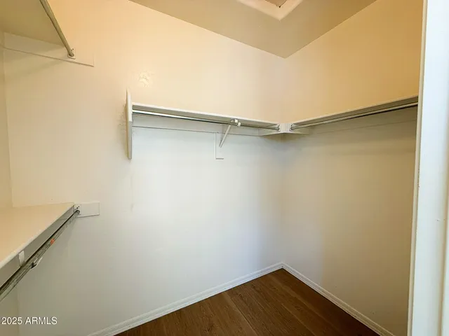 a view of walk in closet with empty racks
