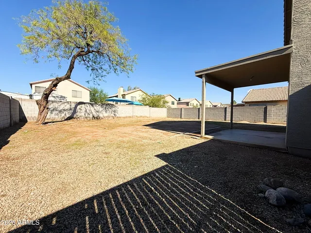 a view of a backyard with table and chairs