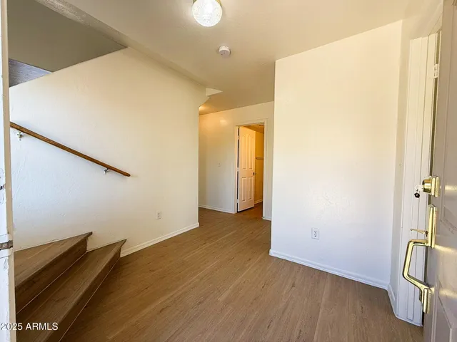 a view of a room with wooden floor