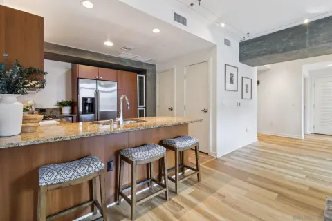 a kitchen with granite countertop a sink and cabinets