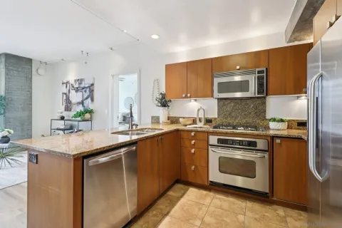 a bathroom with a granite countertop sink a toilet and a shower