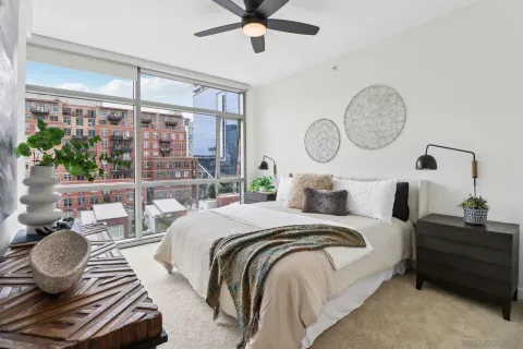 a bedroom with a bed and ceiling fan