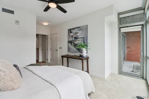 a bedroom with a large bed and a chandelier