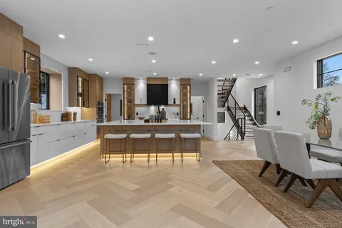 a living room with furniture and large windows