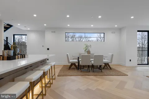 a living room with furniture and a view of kitchen