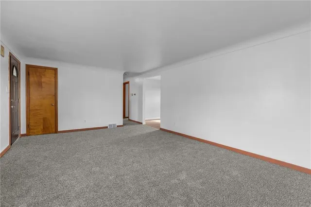 a view of an empty room and closet area