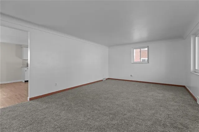 an empty room with a empty space and windows