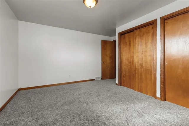 an empty room with closet area