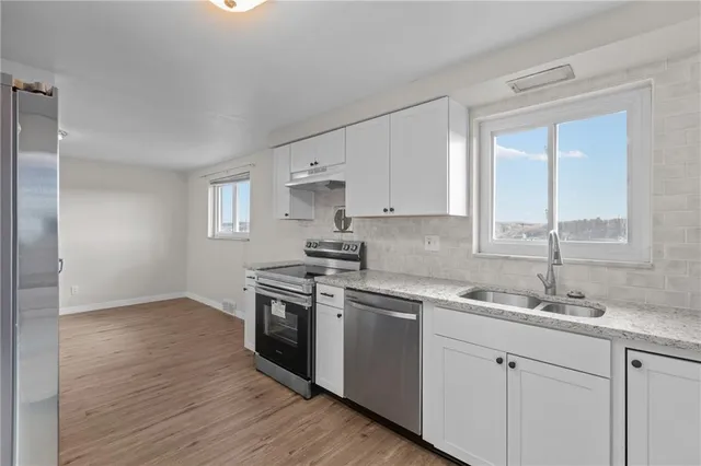 a kitchen with a sink stove and cabinets