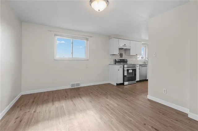 a view of kitchen with granite countertop cabinets and wooden floor