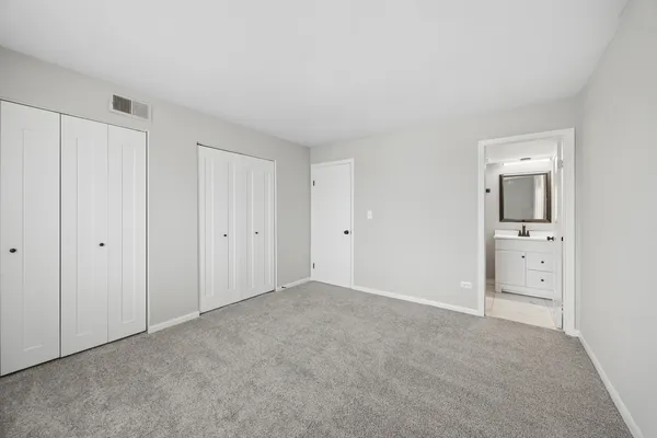 a view of an empty room and closet area