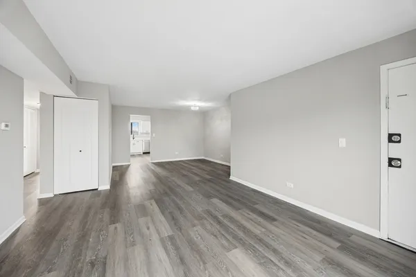 a view of a room with wooden floor and window