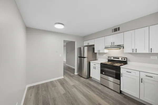 a kitchen with wooden cabinets and stainless steel appliances