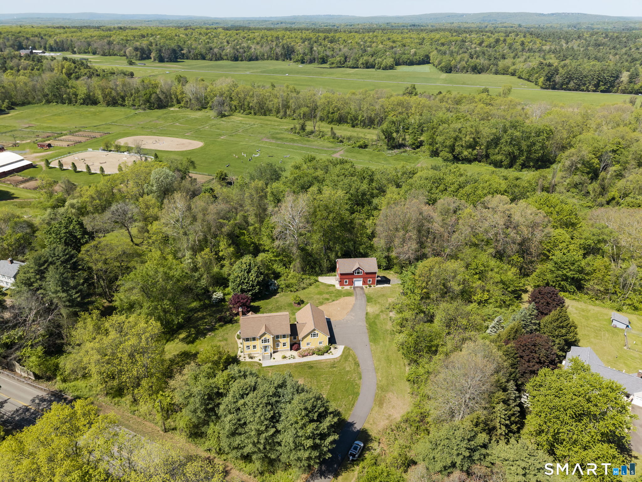 555 Waterville Road Avon, CT 06001 - Photo 2 of 40 an aerial view of residential house with outdoor space and trees all around