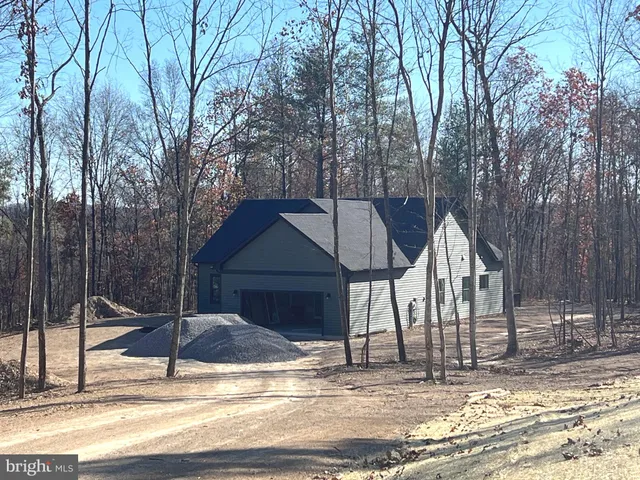 a view of kitchen with stainless steel appliances kitchen island granite countertop a refrigerator and a stove