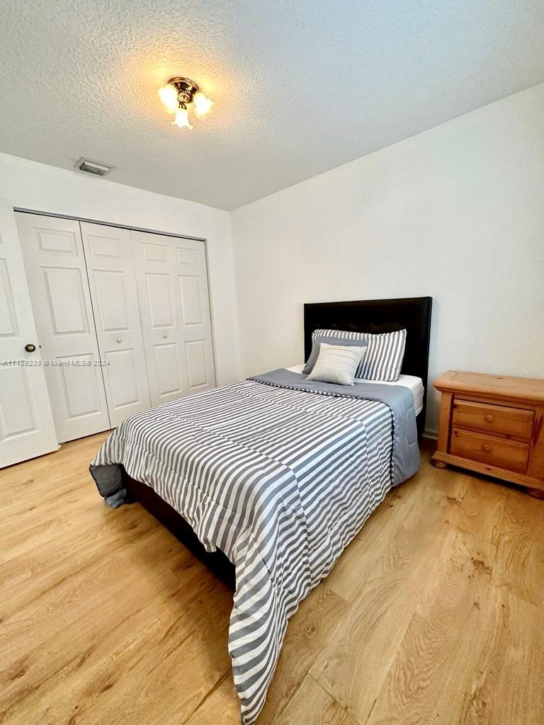 1509 Sunset Way Weston, FL 33327 - Photo 17 of 24 a bedroom with a bed and a window