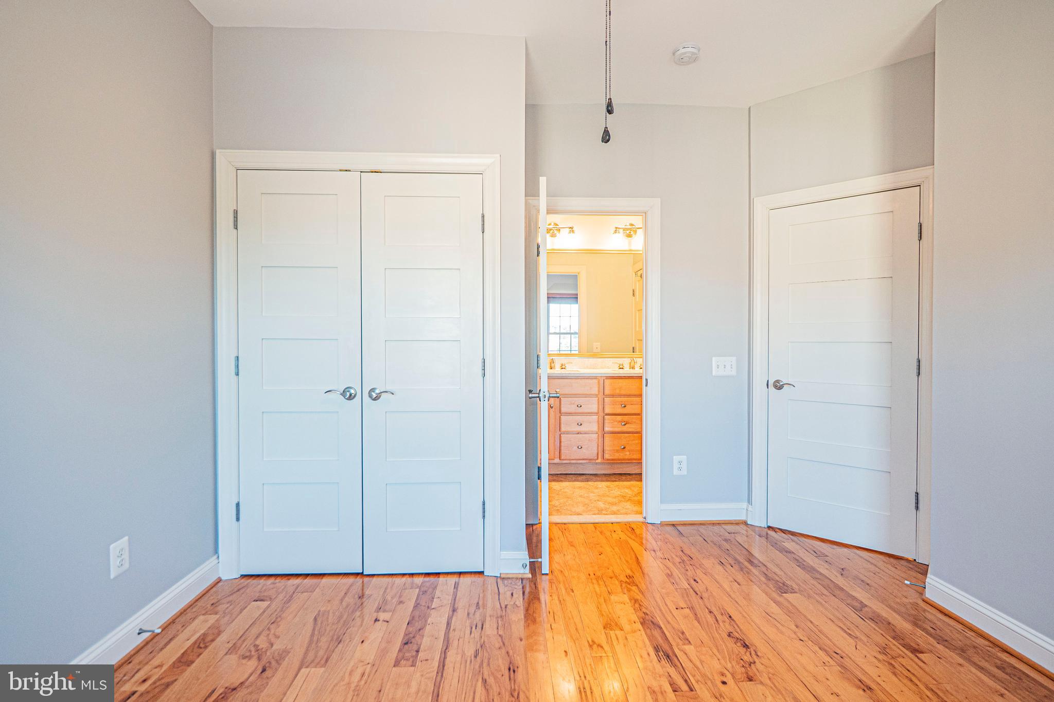 5448 Edsall Ridge Place Alexandria, VA 22312 - Photo 32 of 52 a view of an empty room with closet and wooden floor