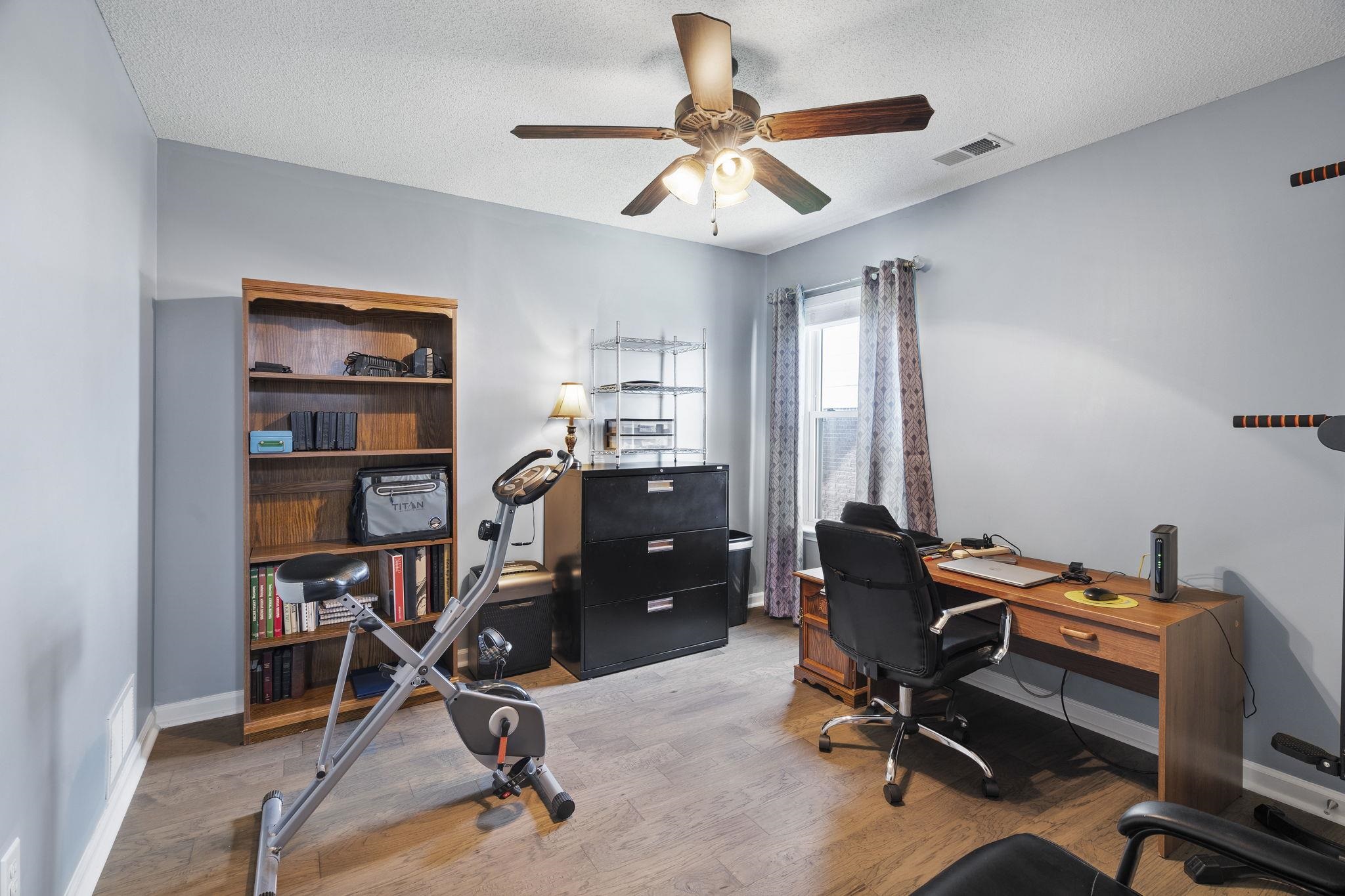 7232 Maple Grove Road Olive Branch, MS 38654 - Photo 16 of 18 Office with light wood-style flooring, a textured ceiling, and ceiling fan