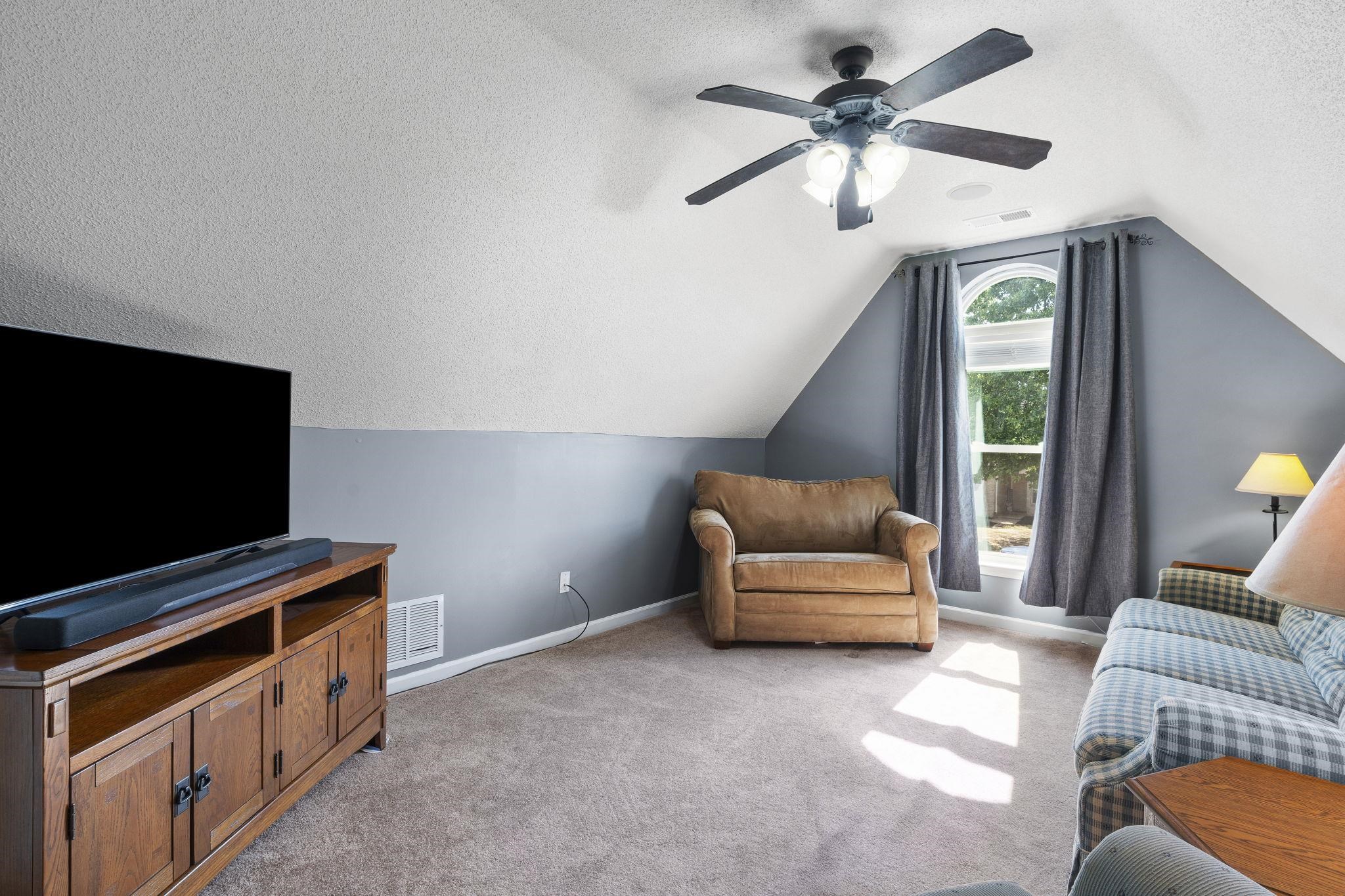 7232 Maple Grove Road Olive Branch, MS 38654 - Photo 10 of 18 Living area featuring a textured ceiling, light carpet, and vaulted ceiling
